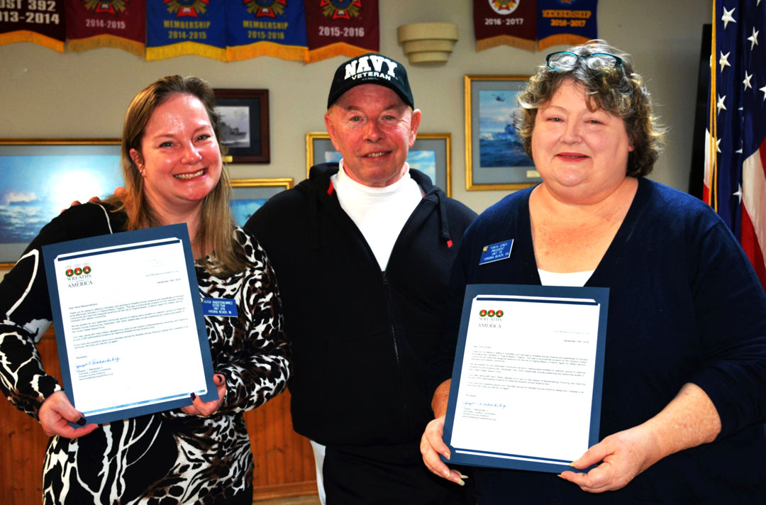 Joseph T. Mahachek, Jr., Volunteer Location Coordinator for Wreaths Across America, (center), presented Letters of Appreciation to American Legion Auxiliary Unit 110 President Tonya Jones (right) and Secretary Alicia Baqueroalvarez (left) at the SSgt Robert C. Melberg, U.S. Army, American Legion Post 110 monthly meeting held on February 26, 2025 in Virginia Beach, VA.  Mahachek praised Baqueroalvarez and Jones for their participation in the laying of wreaths on military veterans graves along with the ceremonial wreath of the United States Space Force during ceremonies held at Princess Anne Memorial Cemetery, Virginia Beach, VA, on December 14, 2024.     (Photography by Bert Wendell, Jr.)